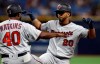 Minnesota Twins' Eddie Rosario (20) celebrates his two-run single off Tampa Bay Rays relief pitcher Adam Kolarek with first base coach Tommy Watkins during the ninth inning of a baseball game Friday, May 31, 2019, in St. Petersburg, Fla. (AP Photo/Chris O'Meara)