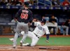 Tampa Bay Rays' Avisail Garcia scores ahead of the throw to Cleveland Indians relief pitcher Phil Maton (88) on a throwing error by first baseman Carlos Santana during the seventh inning of a baseball game Saturday, Aug. 31, 2019, in St. Petersburg, Fla. (AP Photo/Chris O'Meara)