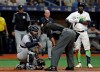Home plate umpire Laz Diaz, center, talks to New York Yankees catcher Gary Sanchez, left, after he was hit on the head on a swing by Tampa Bay Rays' Guillermo Heredia, right, during the eighth inning of a baseball game Saturday, May 11, 2019, in St. Petersburg, Fla. Sanchez stayed in the game. (AP Photo/Chris O'Meara)