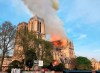 Notre Dame cathedral is burning in Paris, Monday, April 15, 2019. Massive plumes of yellow brown smoke is filling the air above Notre Dame Cathedral and ash is falling on tourists and others around the island that marks the center of Paris. (AP Photo)