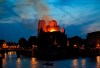 Firefighters tackle the blaze as flames and smoke rise from Notre Dame cathedral as it burns in Paris, Monday, April 15, 2019. Massive plumes of yellow brown smoke is filling the air above Notre Dame Cathedral and ash is falling on tourists and others around the island that marks the center of Paris. (AP Photo/Michel Euler)