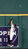 Houston Astros center fielder Jake Marisnick leaps at the wall while trying to catch a home run by Chicago White Sox's Eloy Jimenez during the second inning of a baseball game Wednesday, May 22, 2019, in Houston. (AP Photo/David J. Phillip)
