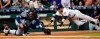 Houston Astros' Josh Reddick (22) dives past Seattle Mariners catcher Omar Narvaez to score during the second inning of a baseball game Saturday, June 29, 2019, in Houston. (AP Photo/David J. Phillip)