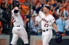 Houston Astros' Jose Altuve (27) is congratulated by teammate Josh Reddick (22) after hitting a two-run home run against the Tampa Bay Rays in the fifth inning during Game 1 in baseball's American League Division Series in Houston, Friday, Oct. 4, 2019. (AP Photo/Michael Wyke)