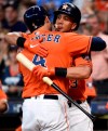 Houston Astros' George Springer, left, hugs Michael Brantley after hitting a solo home run off Los Angeles Angels starting pitcher Jose Rodriguez during the first inning of a baseball game, Sunday, Sept. 22, 2019, in Houston. (AP Photo/Eric Christian Smith)