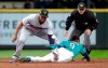 The ball pops away from Minnesota Twins second baseman Jonathan Schoop, left, as Seattle Mariners' Dee Gordon steals second base during the third inning of a baseball game Friday, May 17, 2019, in Seattle. (AP Photo/Elaine Thompson)
