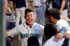 Seattle Mariners' Dylan Moore smiles as he runs to the arms of teammates waiting to congratulate him on his three-run home run against the New York Yankees in the second inning of a baseball game Monday, Aug. 26, 2019, in Seattle. (AP Photo/Elaine Thompson)