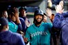 Seattle Mariners' Domingo Santana smiles while being congratulated for his two-run home run against the Houston Astros during the sixth inning of a baseball game Wednesday, June 5, 2019, in Seattle. (AP Photo/Elaine Thompson)