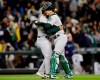 Oakland Athletics closing pitcher Jesus Luzardo and catcher Sean Murphy hug after the 1-0 win over the Seattle Mariners in a baseball game, Saturday, Sept. 28, 2019, in Seattle. (AP Photo/John Froschauer)