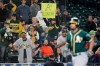A fan holds a sign that reads 