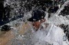 Seattle Mariners right fielder Kyle Lewis is doused with water by a teammate as he takes part in an interview following the team's baseball game against the Cincinnati Reds, Tuesday, Sept. 10, 2019, in Seattle. Lewis hit a solo home run in his major league debut as the Mariners won 4-3. (AP Photo/Ted S. Warren)