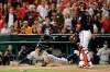 Houston Astros' Carlos Correa scores past Washington Nationals catcher Kurt Suzuki on a single by Josh Reddick during the second inning of Game 3 of the baseball World Series Friday, Oct. 25, 2019, in Washington. (AP Photo/Jeff Roberson)