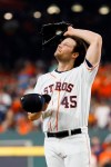 Houston Astros starting pitcher Gerrit Cole wipes his fave after giving up a double to Washington Nationals' Juan Soto during the fifth inning of Game 1 of the baseball World Series Tuesday, Oct. 22, 2019, in Houston. (AP Photo/Matt Slocum)