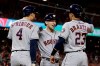 Houston Astros' Alex Bregman, middle, celebrates after his grand slam with George Springer, left, and Michael Brantley against the Washington Nationals during the seventh inning of Game 4 of the baseball World Series Saturday, Oct. 26, 2019, in Washington.(AP Photo/Jeff Roberson)