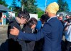NDP Leader Jagmeet Singh talks with Betty Nicolaye and one of her three children as he makes a campaign stop with Rachel Blaney, NDP Candidate for North Island-Powell River, at a Habitat for Humanity project in Campbell River, B.C. on Thursday, Sept. 26, 2019. The family is homeless and living in their van. THE CANADIAN PRESS/Andrew Vaughan