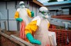 In this photograph taken Saturday July 13, 2019, health workers wearing protective suits take their shift at a treatment center in Beni, Congo DRC. The head of the World Health Organization is convening a meeting of experts Wednesday July 17, 2019 to decide whether the Ebola outbreak should be declared an international emergency after spreading to eastern Congo's biggest city, Goma, this week. More than 1,600 people in eastern Congo have died as the virus has spread in areas too dangerous for health teams to access.(AP Photo/Jerome Delay)