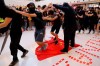 Protesters walk on a Chinese national flag during a protest at a mall in Hong Kong on Sunday, Sept. 22, 2019. Hong Kong's pro-democracy protests, now in their fourth month, have often descended into violence late in the day and at night. A hardcore group of protesters says the extreme actions are needed to get the government's attention. (AP Photo/Kin Cheung)