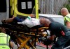 Ambulance staff take a man from outside a mosque in central Christchurch, New Zealand, Friday, March 15, 2019, following a mass shooting. (AP Photo/Mark Baker)