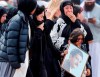 Mourners arrive for a burial service of a victim from the March 15 mosque shootings at the Memorial Park Cemetery in Christchurch, New Zealand, Thursday, March 21, 2019. (AP Photo/Vincent Thian)