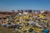 Wreckage is piled at the crash scene of an Ethiopian Airlines flight crash near Bishoftu, or Debre Zeit, south of Addis Ababa, Ethiopia, Monday, March 11, 2019. A spokesman says Ethiopian Airlines has grounded all its Boeing 737 Max 8 aircraft as a safety precaution, following the crash of one of its planes in which 157 people are known to have died. (AP Photo/Mulugeta Ayene)