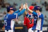 South Korea's Park Min-woo, right, celebrates with first base coach Lee Jong-yeol after hitting an RBI single off Canada's pitcher Dustin Molleken during the 9th inning of the group C of the WBSC Premier12 2019 world baseball tournament at Gocheok Sky Dome in Seoul, South Korea, Thursday, Nov. 7, 2019. (AP Photo/Ahn Young-joon)