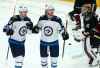 Winnipeg Jets left wing Kyle Connor, middle, celebrates his goal against Arizona Coyotes goaltender Calvin Pickard (30) as Jets center Mark Scheifele (55) joins Connor during the second period of an NHL hockey game Saturday, April 6, 2019, in Glendale, Ariz. (AP Photo/Ross D. Franklin)