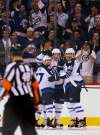 Left to right, Kevin Clark, Ben Maxwell and Mark Scheifele celebrate the second goal Tuesday against Columbus in their first home game in 15 years.
(Phil Hossack / Winnipeg Free Press)