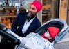 NDP Leader Jagmeet Singh stops to have his picture taken with a baby in a carriage while main streeting in Toronto, on Thursday, October 3, 2019. THE CANADIAN PRESS/Paul Chiasson