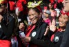 RUTH BONNEVILLE  / WINNIPEG FREE PRESS  Gwyneth Arsenio laughs with fellow members of Aklan Ati-Atihan of Manitoba as they dance on Broadway during the 5th annual Manitoba Filipino Street Festival Saturday.   Aug 16 / 2016