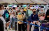 Tourists from Wuhan, China, line up to get a seat on a charter flight returning to Wuhan at Suvarnabhumi airport, Bangkok, Thailand, Friday, Jan. 31, 2020. A group of Chinese tourists who have been trapped in Thailand since Wuhan was locked down due to an outbreak of new virus have returned to China on Friday. (AP Photo/Gemunu Amarasinghe)