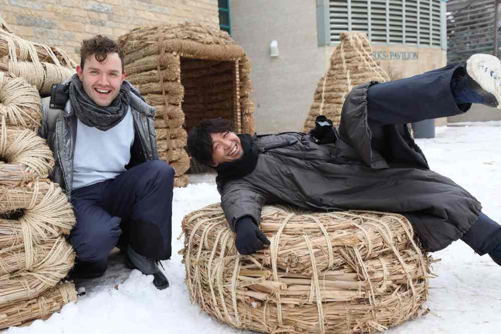 Team members Masato Ashida (right) and Adrian Steckeweh pose for photos in their version of a warming hut at the Forks Friday. The architectural team from Japan showcased what they call Forrest Village for their 2020 entry, one of  the 3 winners in the Forks warming hut competition. (Ruth Bonneville / WInnipeg Free Press)