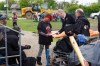 Mark Reshaur, Assistant Chief of the Winnipeg Fire Paramedic Service, hands Desirae Whitehead a pamphlet detailing the order to vacate the homeless camp by Friday while Rick Lees with the Main Street Project looks on. (Mike Deal / Winnipeg Free Press)