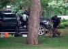 An RCMP officer works with a police dog as they move through the contents of a pick up truck on the grounds of Rideau Hall in Ottawa, Thursday July 2, 2020. THE CANADIAN PRESS/Adrian Wyld