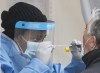 A health-care worker prepares to swab a man at a walk-in COVID-19 test clinic in Montreal North, Sunday, May 10, 2020. For the first time since early May, more than 1,000 new COVID-19 cases were reported in Quebec in a 24 hour period.THE CANADIAN PRESS/Graham Hughes