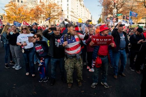 Supporters of President Donald Trump cheer as his motorcade drives past a rally of supporters near the White House, in Washington, Saturday, Nov. 14, 2020. Diehard Donald Trump supporters are gathering in the national capital in solidarity with the president's efforts to defy last week's election results. THE CANADIAN PRESS/AP-Evan Vucci