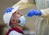 Friaaz Azeez gets tested for COVID-19 from a health care worker at a pop-up testing centre at the Islamic Institute of Toronto during the COVID-19 pandemic in Scarborough, Ont., on Friday, May 29, 2020. THE CANADIAN PRESS/Nathan Denette