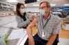 Dr. Brian Penner, with internal medicine at Winnipeg's Health Sciences Centre, receives the first COVID-19 inoculation in Manitoba from LoriAnn Laramee, a public health nurse, in the COVID-19 vaccination clinic at the Health Sciences Centre on Wednesday, Dec. 16, 2020. THE CANADIAN PRESS/John Woods