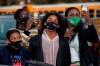 A family listens to vice-president-elect Kamala Harris speak at a drive-in rally during a campaign stop for Democratic U.S. Senate candidates Rev. Raphael Warnock and Jon Ossoff, Sunday, Jan. 3, 2021, in Savannah, Ga. THE CANADIAN PRESS/AP/Stephen B. Morton