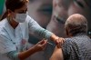 A man receives a COVID-19 vaccine from medical staff at a COVID-19 vaccination center in Tel Aviv, Israel, Wednesday Jan. 6, 2021. THE CANADIAN PRESS/AP/Oded Balilty