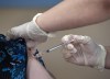 A registered nurse on staff at the Northwood Care facility, administers a dose of the Moderna vaccine to Ann Hicks in Halifax on Jan. 11, 2021. THE CANADIAN PRESS/Andrew Vaughan-Pool
