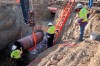 In this April 13, 2020, photo provided by TC Energy, construction contractors for TC Energy are seen installing a section of the Keystone XL crude oil pipeline at the U.S.-Canada border north of Glasgow, Mont. THE CANADIAN PRESS/AP-TC Energy via AP