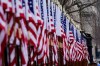 A worker installs flags on Pennsylvania Avenue in front of the White House ahead of President-elect Joe Biden's inauguration ceremony, Tuesday, Jan. 19, 2021, in Washington. THE CANADIAN PRESS/AP/David Phillip