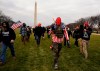 In this Jan. 6, 2021, file photo, people march with those who say they are members of the Proud Boys as they attend a rally in Washington in support of President Donald Trump. THE CANADIAN PRESS/AP/Carolyn Kaster,