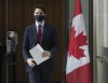 Prime Minister Justin Trudeau makes his way to a news news conference in Ottawa, Friday, Feb. 19, 2021. The National Firearms Association has been censured by a House of Commons committee for making inflammatory comments about the Trudeau government's recent gun control legislation. THE CANADIAN PRESS/Adrian Wyld