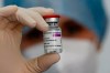 A health worker holds up a dose of the AstraZeneca vaccine against COVID-19 in Rome, Tuesday, Feb. 23, 2020. (Cecilia Fabiano/LaPresse via the Associated Press)