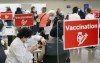 A man receives his COVID-19 vaccine at a clinic at Olympic Stadium marking the beginning of mass vaccination in the Province of Quebec based on age in Montreal, on Monday, March 1, 2021. THE CANADIAN PRESS/Paul Chiasson