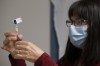 Heather Witzel-Garnhum, nurse clinician, prepares a syringe with the Pfizer-BioNTech COVID-19 vaccine at the Regina General Hospital in Regina on December 15, 2020. THE CANADIAN PRESS/Michael Bell