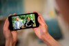 A man watches a phone screen showing an interview of Prince Harry and Meghan, The Duchess of Sussex, by Oprah Winfrey, in London Monday, March 8, 2021. THE CANADIAN PRESS/Aaron Chown/PA via AP