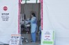 A hospital worker is seen at a staff COVID-19 assessment area outside Lions Gate Hospital in North Vancouver on Wednesday, March 18, 2020. THE CANADIAN PRESS/Jonathan Hayward