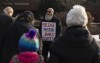 Supporters pray outside as Pastor James Coates of GraceLife Church is in court in Stony Plain, Alta., on Wednesday Feb. 24, 2021, after being charged with holding Sunday services in violation of COVID-19 rules. THE CANADIAN PRESS/Jason Franson